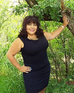 Debbie Blanc leaning on a tree